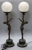 A pair of Art Deco style bronzed metal table lamps, the bases formed as female nudes with