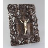 A late 18th/early 19th century Flemish walnut and ivory crucifix, carved with Christ upon a