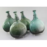 Four Persian green glass saddle flasks, 18th/19th century, each with a cable applied around the