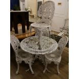 A set of four white painted cast aluminium Coalbrookedale style garden chairs and a matching table