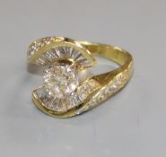 A modern 18k gold and single stone diamond ring and baguette cut diamond setting, the central