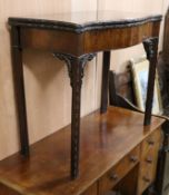 A George III mahogany serpentine tea table W.85cm