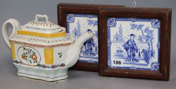 Two framed blue and white tiles depicting an Oriental scene and a faience colours teapot