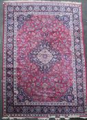 A Meshed red and blue ground, carpet 5.03 x 3.43 with central medallion in a field of floral motifs,