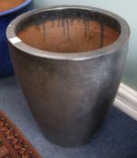 A black glazed pottery garden urn, diameter 49cm