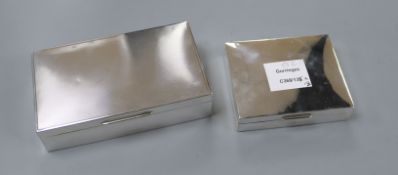 Two mid 20th century silver cigarette boxes, largest 15.6cm.