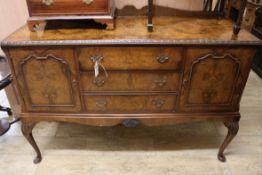 A 1930's walnut sideboard, on cabriole legs W.139cm