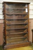 A glazed shop display table cabinet fitted eight long side-opening drawers, each with carved and