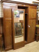 An Edwardian chequer inlaid mahogany triple wardrobe, with central mirrored door W.190cm