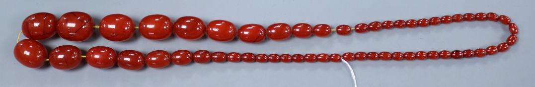 A single strand graduated simulated pale cherry amber bead necklace, gross weight 164 grams, approx.