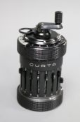 A Curta cylindrical mechanical calculator, circa 1950, in black plastic canister