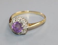 An early-mid 20th century yellow metal, amethyst and diamond set cluster ring, size P.