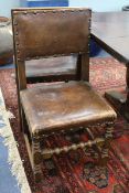 A set of eight Cromwellian style oak dining chairs upholstered in brass studded hide (two with