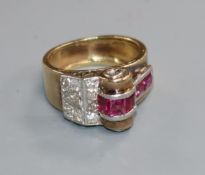 A 1950's? yellow metal, ruby and diamond cluster cocktail ring, size K.