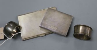 Two silver cigarette cases and two silver napkin rings.