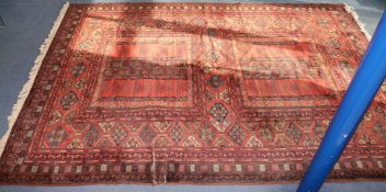 A red ground carpet, 350 x 246cm