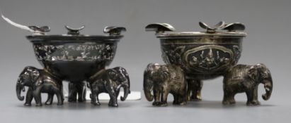 A pair of Indian white metal ashtrays on tripod elephant supports, height 5.5cm.