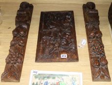 A Flemish small semi-relief carved oak panel of Abraham and Isaac and two carved oak terms length