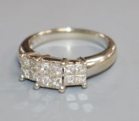 An 18ct white gold and princess cut diamond triple cluster ring, size M.