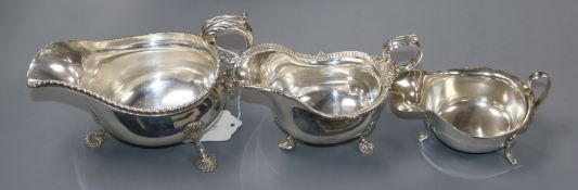 An Edwardian silver sauceboat, C.S. Harris & Sons, London, 1907 and two other silver sauceboats,