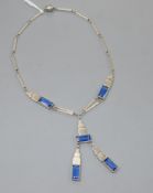 An Art Deco white metal and blue paste set drop tassle necklace, 56cm.