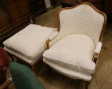 A Louis XV-style walnut fauteuil and matching stool