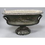 An oval cast iron classical French planter with marble plinth length 41cm