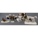 A pair of Staffordshire poodles standing on plinth bases and various animal models, including a