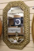 An Arts and Crafts brass overlaid mirror W.44cm