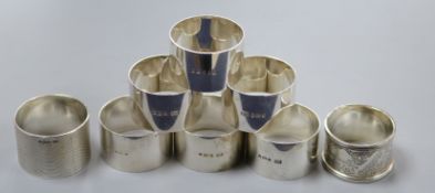 A set of six silver napkin rings and two other silver napkin rings.