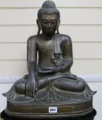 A 19th century Burmese bronze Buddha inset ebony and ivory eyes seated on bespoke lotus-carved