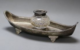 A late Victorian silver boat-shaped ink stand, fitted single silver-mounted cut glass bottle,