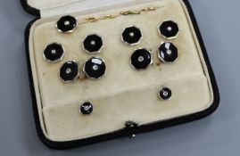 A cased matched set of 9ct/18ct gold and platinum, black onyx and diamond set dress studs.