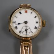 An early 20th century 9ct gold manual wind wrist watch on a 9ct gold bracelet.