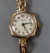 A lady's early 20th century 9ct gold manual wind wrist watch, with Rolex dial and case, movement