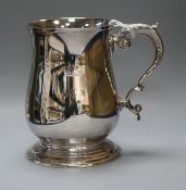 A Roberts & Belk silver baluster mug with scrolled handle, crested and initialled, Sheffield 1987,