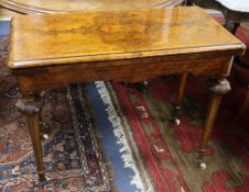 A Victorian figured walnut card table with folding top W.92cm