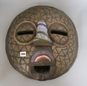 An African Luba style mask decorated with beadwork diameter 43cm