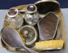 A collection of silver-mounted and tortoiseshell dressing table items, comprising a shaped oval