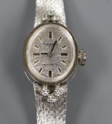 A lady's 14ct white gold and diamond set Anker manual wind wrist watch, on integral 14ct white