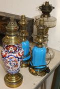 A pair of blue glass oil lamps, a cut glass oil lamp, all converted to electricity and an Imari