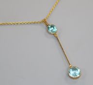 An early 20th century 9ct gold and blue zircon set drop pendant necklace, pendant 46mm.