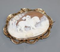 A late Victorian yellow metal mounted 'Love Conquers All' carved oval cameo brooch, 6cm.