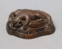 A Japanese wood carving of a sleeping leopard length 15.5cm