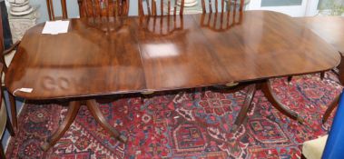 A George III mahogany twin pillar extending dining table (one spare leaf) W.233cm