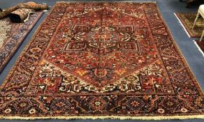 A Heriz red ground carpet 347 x 255cm
