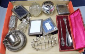 A silver toastrack, three photograph frames, scent bottles etc.