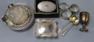 A silver trinket box, a sterling dish, three silver napkin rings, cased silver brush, silver egg cup