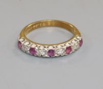 An 18ct gold, ruby and diamond half-hoop ring, size M.