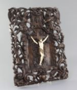 A late 18th/early 19th century Flemish walnut and ivory crucifix, carved with Christ upon a